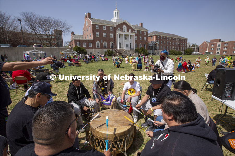 Omaha White Tail drummers play and sing during the UNITE powwow. 2022 UNITE powwow to honor graduates (K through college). Held April 23 on the greenspace along 17th Street, immediately west of the Willa Cather Dining Center. This was UNITE’s first powwow in three years. The MC was Craig Cleveland Jr. Arena director was Mike Wolfe Sr. Host Northern Drum was Standing Horse. Host Southern Drum was Omaha White Tail. Head Woman Dancer was Kaira Wolfe. Head Man Dancer was Scott Aldrich. Special contest was a Potato Dance. April 23, 2023. Photo by Troy Fedderson / University Communication.